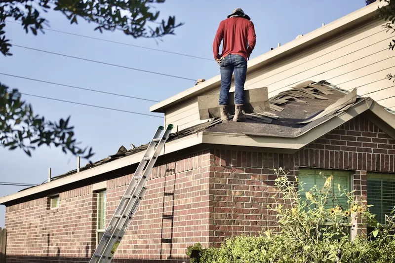 Professional roofer working on a residential roof in Taylor Town